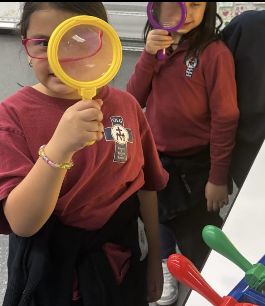 Student investigating with a magnifying glass